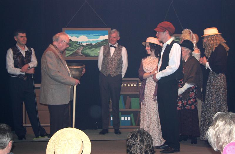 Pot of Gold.jpg - Lord Letchalot receives the Pot of Gold that Amy found under the rainbow, in exchange for the ownership of all the village houses and shops. 
